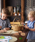 Kids playing with Dig Up Dinosaur Fossil Eggs Kit Break Open Twelve Unique Dino Eggs Uncover Twelve Adorable Dinosaurs Easter STEM Toy