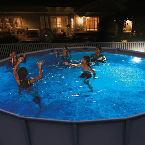 Night scene of a pool illuminated by a Magnetic Above Ground Pool Light With LED Underwater Glow, showing swimmers enjoying night swimming.