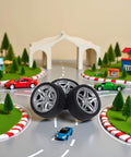 Four Piece 48MM Rubber Toy Car Wheel Set For RC Models, shown in a model race track environment, emphasizing toy car use.