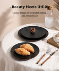 Venus 12 Piece Stoneware Plates And Bowls Set With Trim Chip Resistant Dinnerware For Four Matte Black on table
