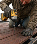 Man using a drill to install Ride Tough 5/16-18 By 2-1/2 Inch Trailer Deck Screws on trailer floorboards.