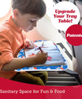 Child using Kids Airplane Tray Table Cover with Storage Pockets for Toys and Snacks Portable Travel Organizer with Dino theme.