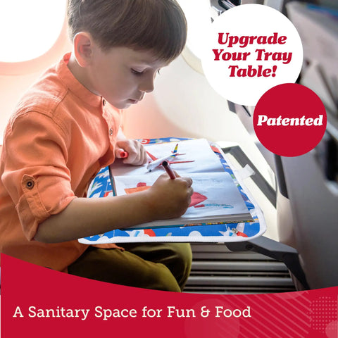 Child using Kids Airplane Tray Table Cover with Storage Pockets for Toys and Snacks Portable Travel Organizer with Dino theme.