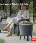 Modern Outdoor Bar Table With Built In 7.5 Gallon Beer And Wine Cooler For Backyard Gameday Parties And Poolside Hangouts A Portable Pop Up Bar With Hidden Cooler Lid Lifts For Quick Drinks On The Deck And Chill Vibes Dark Grey shown as a side table on a patio.