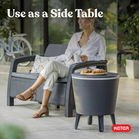 Modern Outdoor Bar Table With Built In 7.5 Gallon Beer And Wine Cooler For Backyard Gameday Parties And Poolside Hangouts A Portable Pop Up Bar With Hidden Cooler Lid Lifts For Quick Drinks On The Deck And Chill Vibes Dark Grey shown as a side table on a patio.