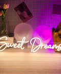 Lit Neon Sign Wall Art Decor 25x6.4 Inches Real LED Neon Light for Bedroom Office Dorm Farmhouse Vibe Aesthetic Room Decor Valentine Party Hanging Sign showing 'Sweet Dreams' in white neon