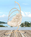 Swing Egg Chair With Stand For Indoor Outdoor Use, Durable Wicker Rattan Basket With UV Resistant Cushions, Beige Color on balcony
