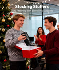 Two men exchanging a Rugged Portable Bluetooth Speaker With 24W Stereo Sound Deep Bass TWS Pairing IPX7 Waterproof during a festive gift exchange.