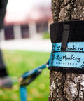60 Feet Slackline Kit With Tree Guards in use around tree, showcasing durable material and outdoor setup for family fun