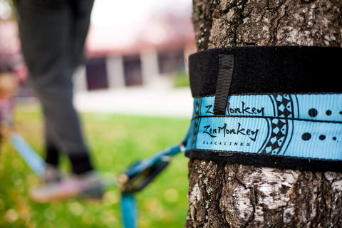 60 Feet Slackline Kit With Tree Guards in use around tree, showcasing durable material and outdoor setup for family fun