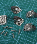 1 Inch Swivel Caster Wheels 8 Pack Mini Furniture Rollers With Self Adhesive Mounts Stainless Steel Nylon Core on a cutting mat with screws.