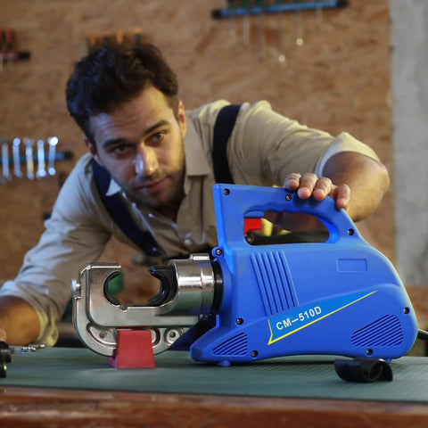 Heavy Hitter 15 Ton Electric Hydraulic Cable Lug Crimping Tool with blue casing and crimping head on a workbench.