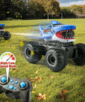 Beast Amphibious Remote Control Shark Monster Truck For Water Play in action on grass with wireless controller, perfect for off-road fun