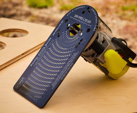 Circle Cutting Router Jig With Pro Grade Precision For Making Perfect Circles From Two And A Quarter Inches To Eighteen And One Sixteenth Inches In One Sixteenth Inch Increments 256 Circle Sizes Industrial Grade Polycarbonate Lifetime Guarantee showing template with router on wood surface.