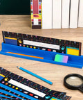Desk Name Plates Holder Set For Classroom with chalkboard style name tags and tape on desk, includes rulers and stationary.
