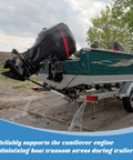 Side view of AHIER adjustable boat transom saver mounted on a green boat trailer, supporting a tilted outboard motor.
