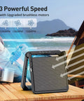 11.5 Inch Portable Solar Powered Fan with Battery Backup on table, ocean view, for camping and outdoor travel.