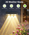 Legit Solar Fence Lights 12 Pack Dang Bright 3 LED Lens waterproof lights illuminating flowers in rain at night.