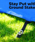 Close-up of ground stakes securing Foldable 10 Foot Dog Agility Tunnel With Carry Bag And Ground Spikes on grass, ensuring stability.