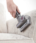 Using Ball Animal 2 Corded Vacuum Renewed Premium with Beast Mode Suction cleaning couch upholstery