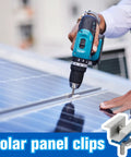 Person installing adjustable solar panel mounting bracket clamps kit on aluminum roof with drill