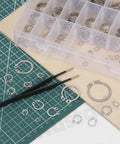 211 Piece External Snap Ring Kit in 304 Stainless Steel with tweezers on a cutting mat, 21 sizes for machinery use