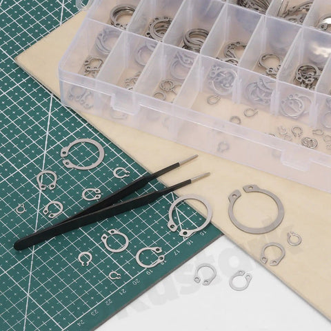 211 Piece External Snap Ring Kit in 304 Stainless Steel with tweezers on a cutting mat, 21 sizes for machinery use
