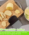 Large wavy crinkle cutter with stainless steel blade and black plastic handle on wooden board with potato slices.