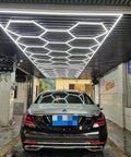 Honeycomb LED Garage Light Kit With 17 Panels And 660W Pro Grade Total Power 6500K Daylight White installed in a car detailing garage