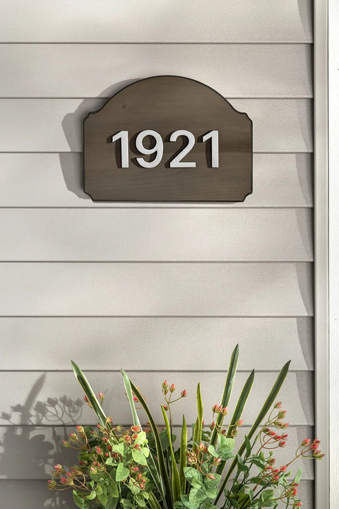 House number 1921 on dark wood plaque above flowers, showcasing use of No Mess Wood Stain And Applicator Kit, 4 Oz Dark Walnut.