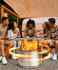 Group enjoying bonfire with heat deflector for fire pits and bonfires, 304 stainless steel heat diffuser redirects warmth at campsite.