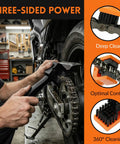 Person using Two Pack Chain Cleaner Brush For Motorcycle And Bicycle Chains With Dual Ended Design Three Sided And Long Bristles Scrub Tool Dirt Remover For Crankset And Gear Keeps Chains Smooth And Shiny on motorcycle gear in garage, showing three-sided cleaning power.