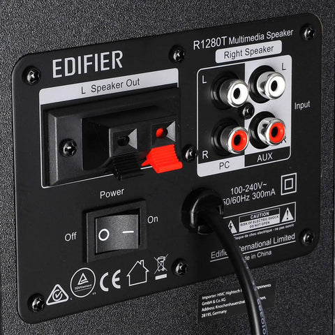 Back panel of R1280T Powered Bookshelf Speakers For Studio Monitoring 2.0 Active Near Field Monitors with inputs and controls.