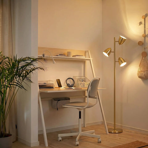 Tall LED Floor Lamp With Adjustable 3 Light Tree In Antique Brass Gold Finish in a cozy home office corner