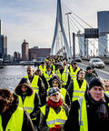 Group wearing Hi Vis Construction Safety Vests 10 Pack Yellow Reflective Vests with Pockets for Men and Women on a bridge.