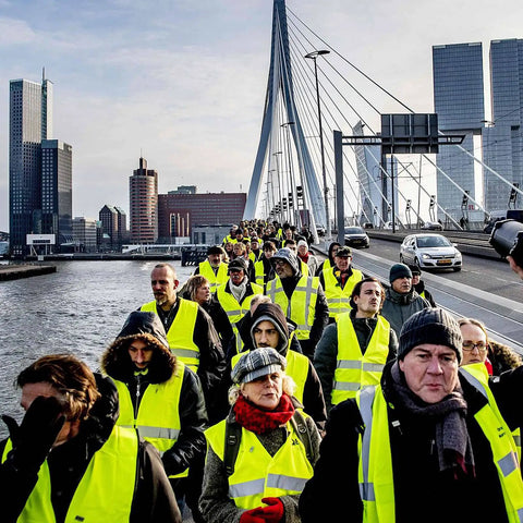 Group wearing Hi Vis Construction Safety Vests 10 Pack Yellow Reflective Vests with Pockets for Men and Women on a bridge.