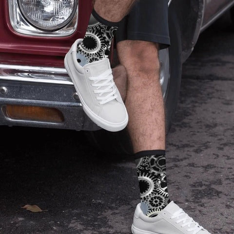 Man wearing Gearhead Engineering Crew Socks for Men and Women Funny Mechanical Novelty Footwear next to vintage car