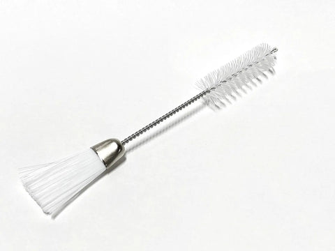 Double-headed lint brush from Must Have Sewing Machine And Overlock Serger Maintenance Kit for quick fixes and easy home service.