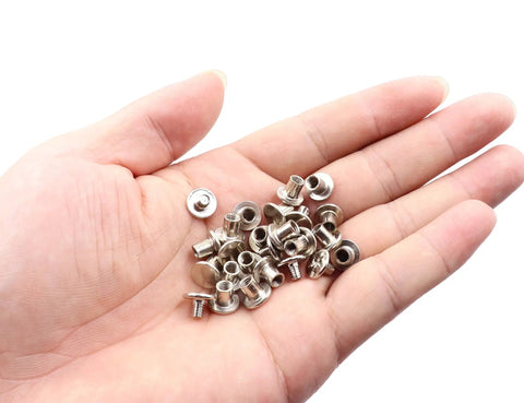 Heavy Duty Nickel Plated Chicago Screws 100 Sets M5 X 6mm Binding Screw Posts in hand, showcasing metal fasteners for leathercraft.