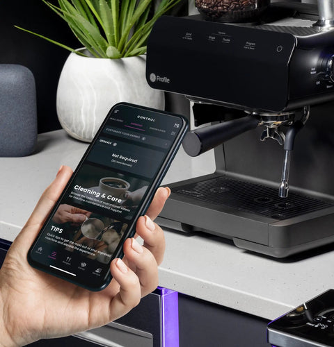 Next Level Semi Automatic Espresso Machine With Built In Grinder Steam Frother Featuring Italian Made 15 Bar Pump For Straight Up Perfect Shots Plus Wifi Connected Custom Brewing In Slick Black with smartphone app showing features.