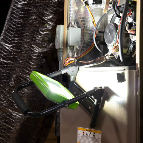 Beefy 2400 Lumen LED Work Light with foldable magnetic base illuminating a metal surface in a workshop setting