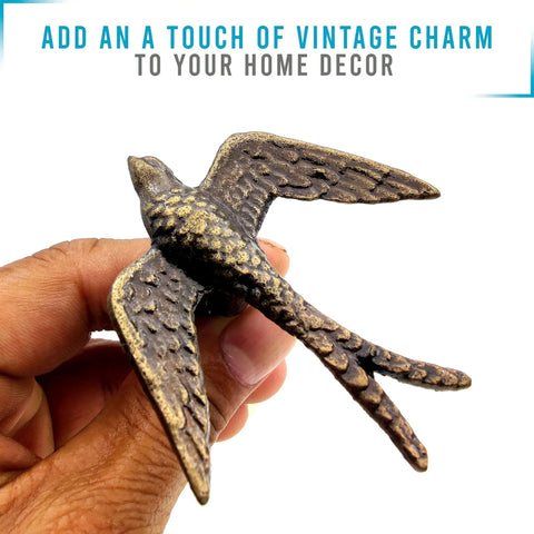Close-up of hand holding a bird design handle from Vintage Cast Iron Closet Door Pull Handles In Bronze Finish With Delicate Bird Design Set Of 2.
