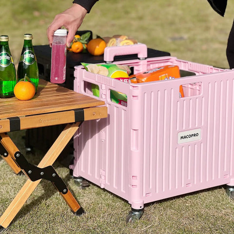 Foldable Utility Cart With Four Swivel Wheels And Lid, Portable Rolling Handcart for groceries, pink cart beside wooden table