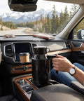 Portable 1300Ml Car Electric Kettle 12V And 24V Plug steaming in car cup holder, ideal for brewing coffee or tea on the go.