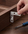100-Piece Stainless Steel L-Shape Corner Bracket Set for 2x2 Inch Small Angle Joints installation on wooden surface