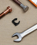 Two Pack Nylon Water Pipe Clamps For Marine Use with tools, bolt, and wrench on textured surface