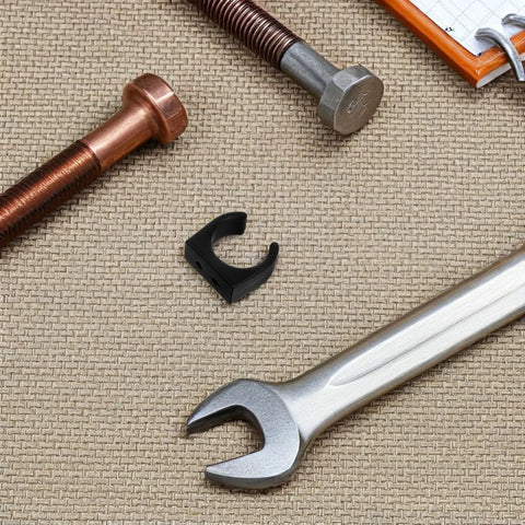 Two Pack Nylon Water Pipe Clamps For Marine Use with tools, bolt, and wrench on textured surface