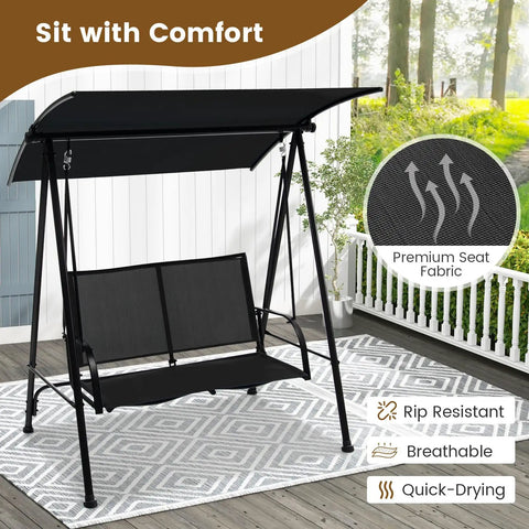 Two Person Outdoor Swing With Adjustable Canopy Cozy Patio Loveseat Swing With Heavy Duty Metal Frame in backyard setting