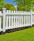 White fence anchored with Heavy Duty Fence Post Anchor Ground Spike 24 Inch Metal Post Base Fits 3.6 by 3.6 Inch