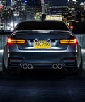 Stainless Steel License Plate Screws Kit With M6x20mm Hardware For Front Or Rear Mount, installed on car's rear plate in cityscape at night.